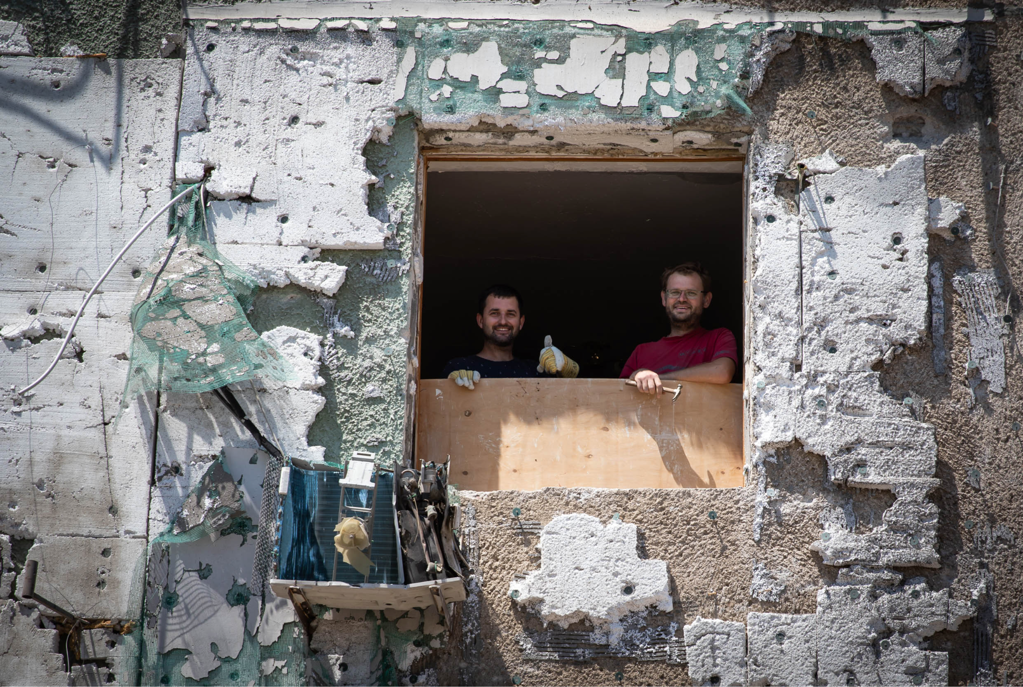 Andrew and Oleh repairing the apartment of their former schoolteacher, Serhiivka, Odesa region