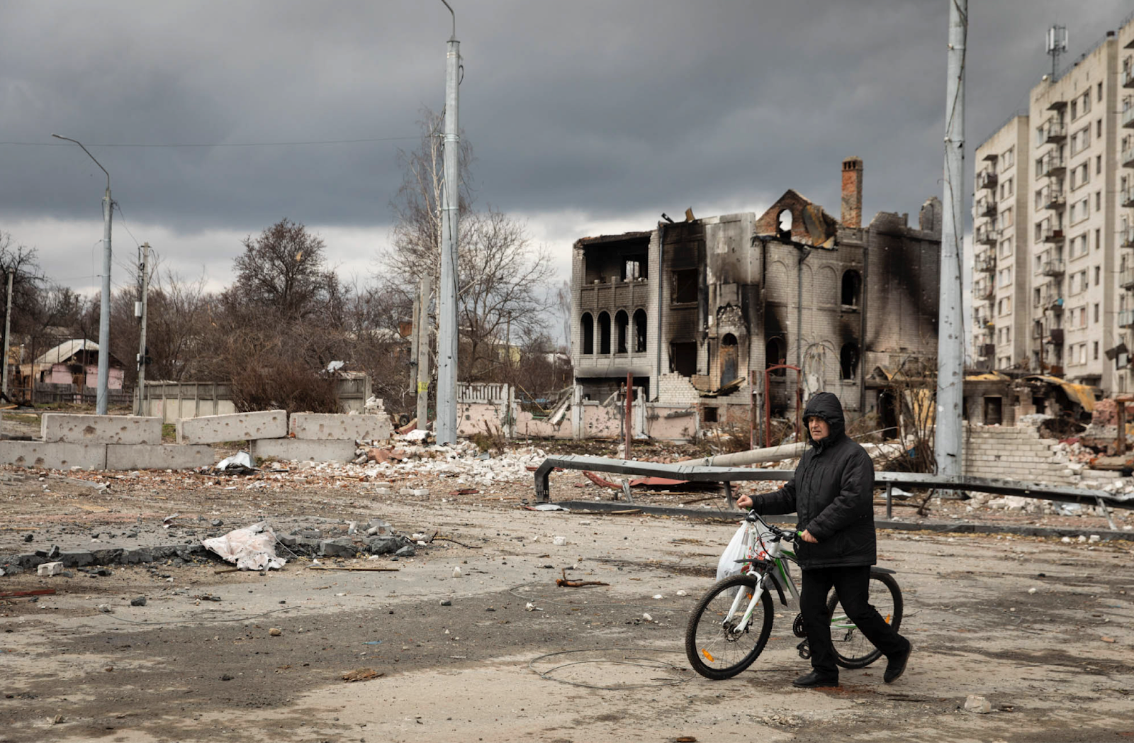 Man walking through destroyed Chernihiv city center
