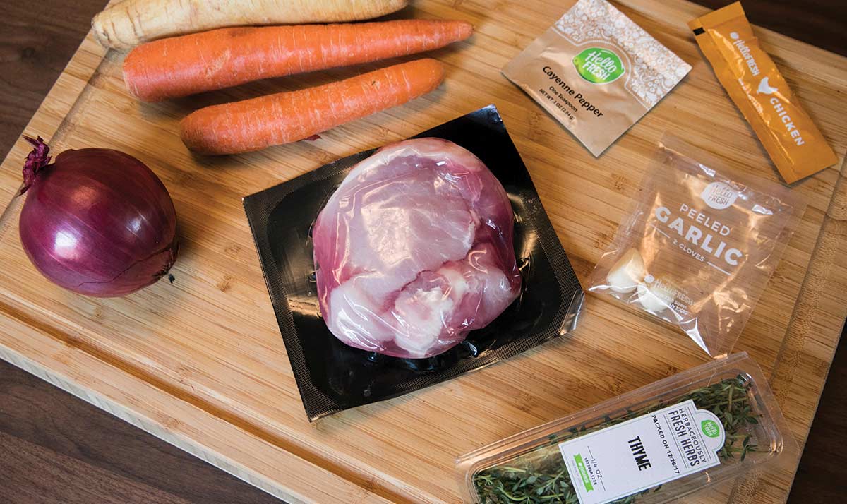 Raw cooking ingredients on a wooden cutting board