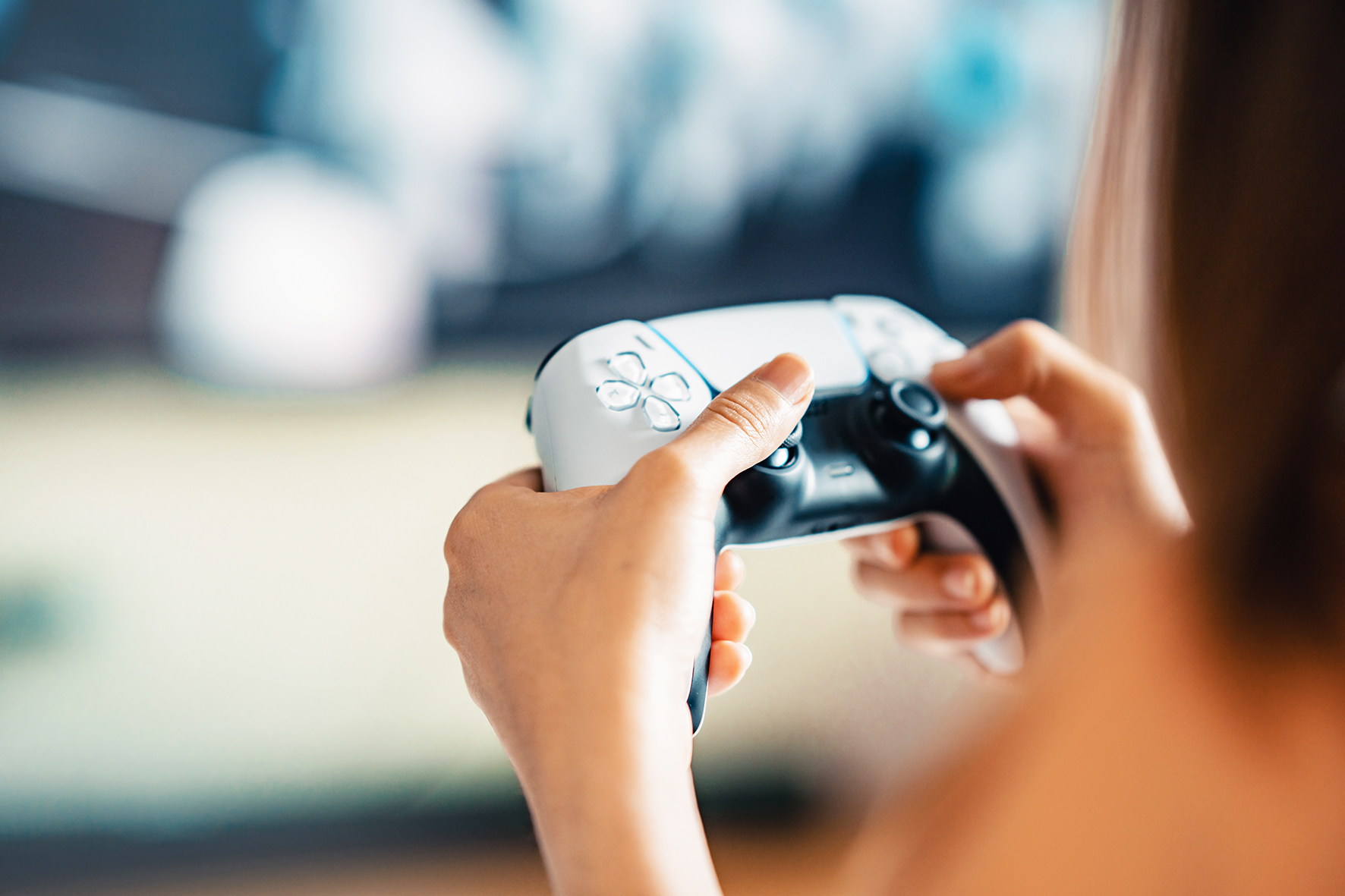 Eine Person, die einen Gaming-Controller bedient.