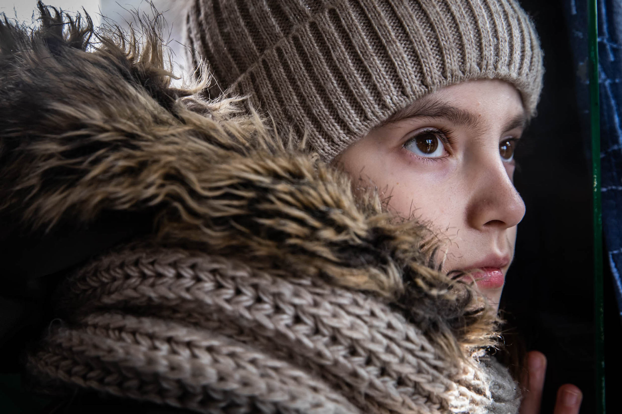Lena,15, staring ahead while on an evacuation bus from Mykolaiv to Chisinau. 