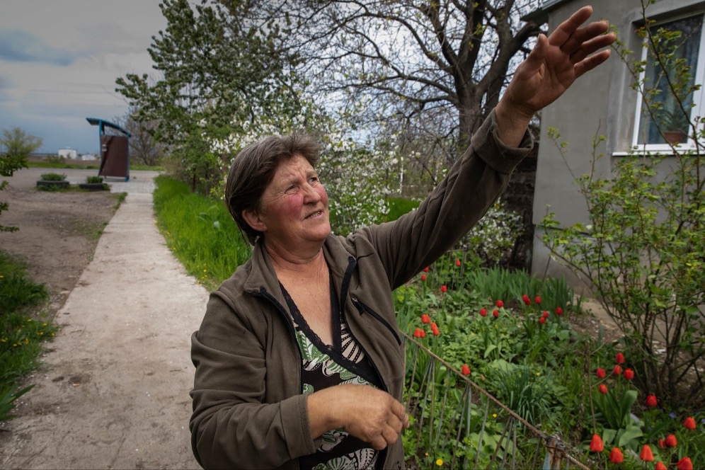 A villager in Gorohovka points to where a missile damaged her home.