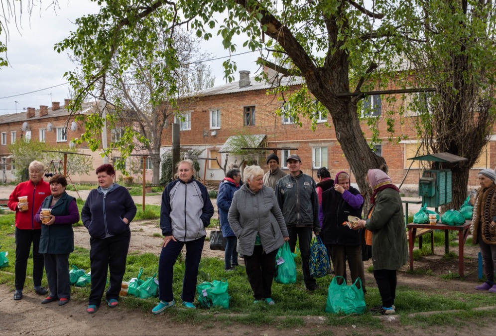 Villagers gather for aid distribution in Gorohovka, Ukraine.