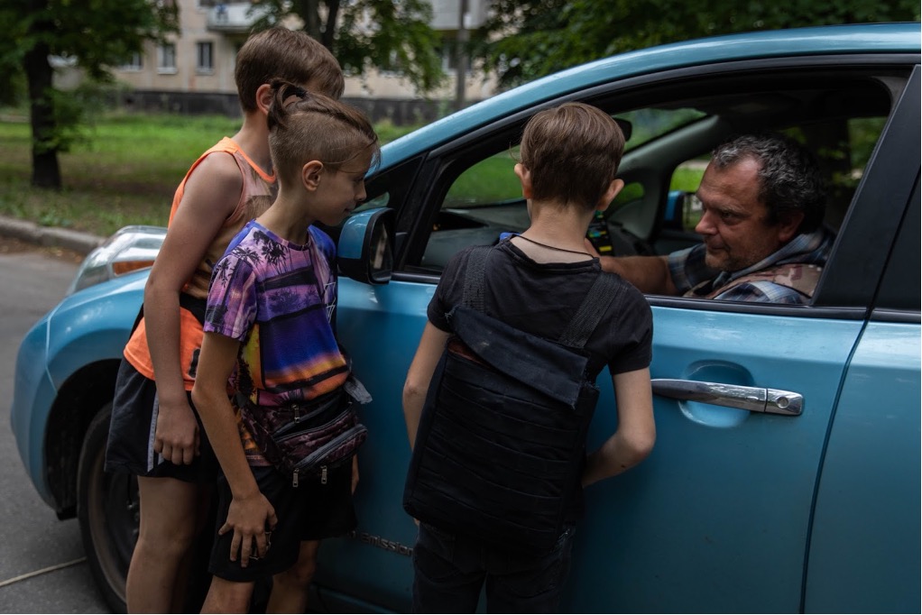 Artem plays along with three young boys who were operating a pretend checkpoint in Kharkiv, Ukraine.