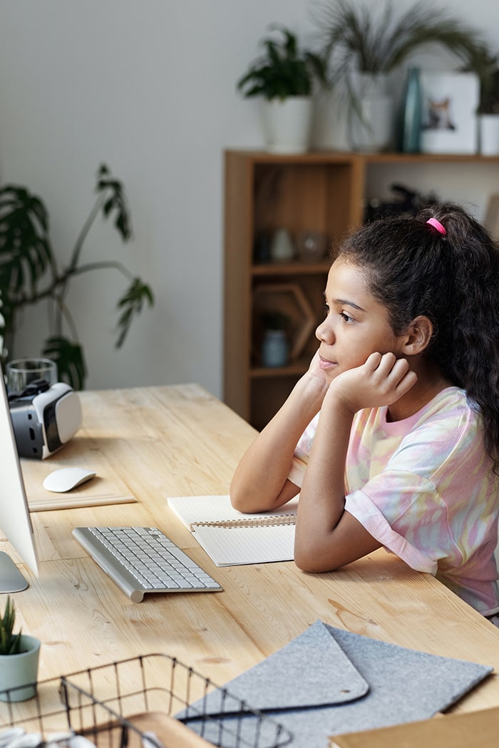 girl in pink sitting by the table