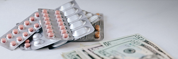 Image of pills with US dollars in cash