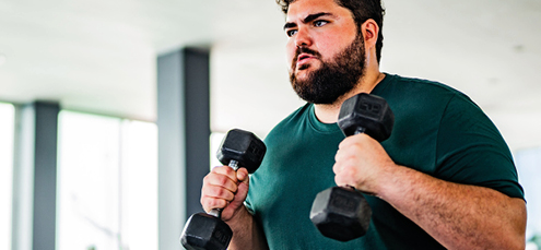 plus-sized man working out with weights