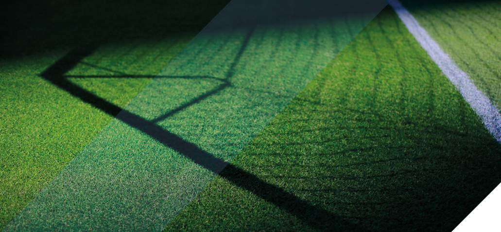 shadow of a football goal on a green pitch