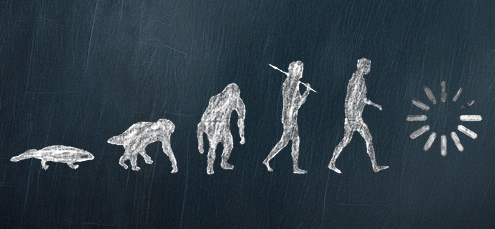 chalboard drawing of the evolution of man from fish to computer 'loading' symbol