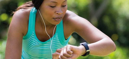 african-american woman looking at heart rate on smartwatch