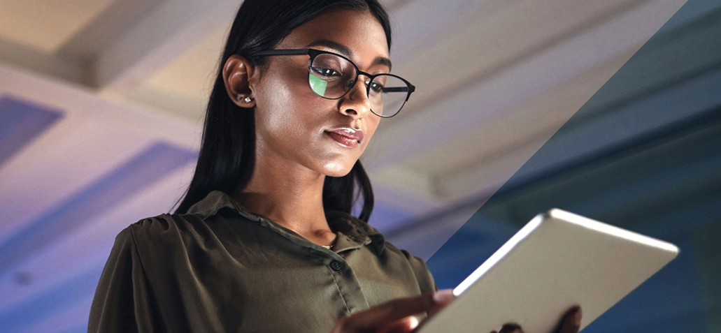 Young woman accessing data on tablet