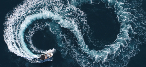 speedboat creates a figure-eight on the ocean