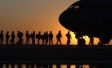 Military personnel boarding an aircraft