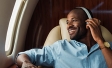 how do the European Affluent travel the world? | man wearing headphones on plane | Ipsos | Europe Affluent Survey