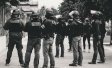 Greyscale image of armed police grouped together