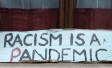 Sign saying "Racism is a Pandemic" 