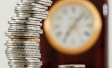 Silver and gold coins with clock in backhground