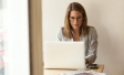 Woman working at computer at table