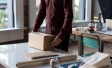 Person wrapping package for delivery