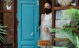 Woman wearing mask opening her store