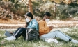 Two Women Sitting Outside Wearing Masks