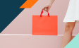 Woman holding an orange shopping bag