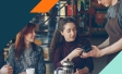 Image of woman paying a waiter at a restaurant with a credit card