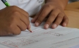 Pupil writing in a classroom