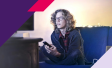 Image of a person watching TV while sitting on a couch