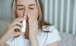 Woman with nasal spray