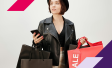 Image of woman shopping while holding a phone
