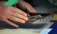 person putting money in wallet while doing paperwork