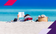 person sitting on beach reading a book