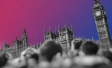 Black-and-white photograph-style view of a blurred crowd in front of the Palace of Westminster