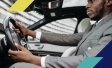 Image of a man driving a car wearing a suit