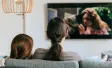 2 people watching television