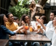 a group of peopel celebrating and toasting with alcoholic and non-alcoholic drinks