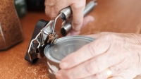 older person using a can opener