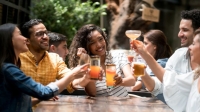 a group of peopel celebrating and toasting with alcoholic and non-alcoholic drinks
