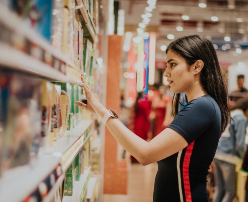 young woman browsing suppermarket shelves
