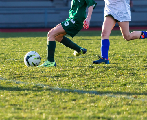 2 girls playing football