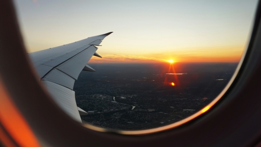 image of setting sun see through an airplane window