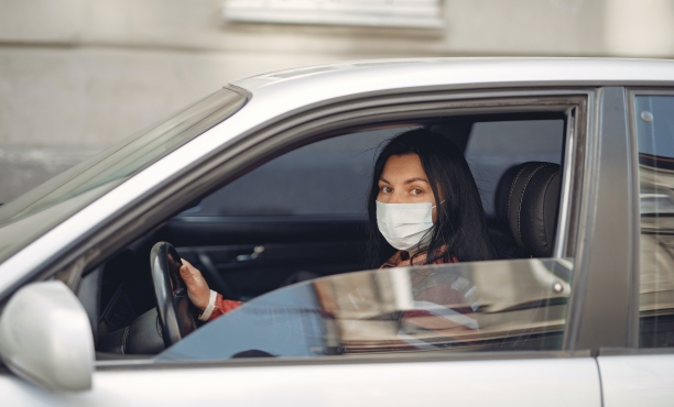 young woman wearing face mask in her car | Ipsos | What worries the world
