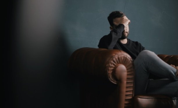 Worried man sitting on sofa