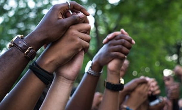 Holding hands together | Intolerance | Racism | Coronavirus | Ipsos | ESSENTIALS