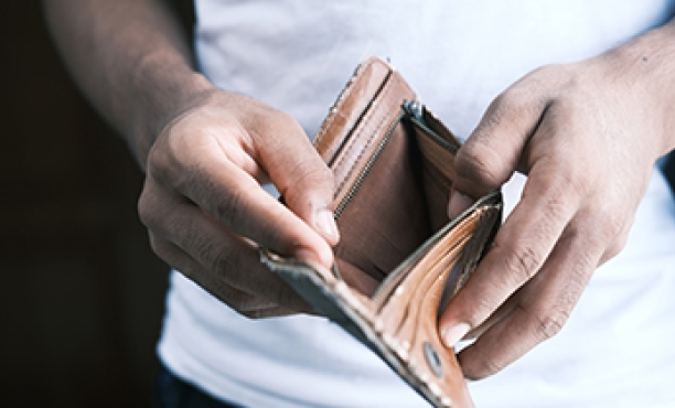 Man holding an empty wallet