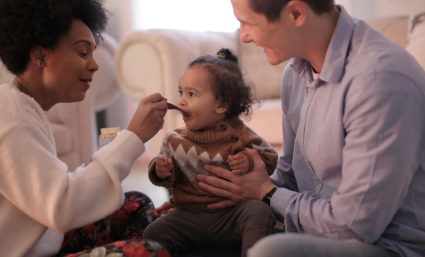 Family feeding a child