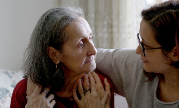 A young woman with her arm around the shoulders of an older woman