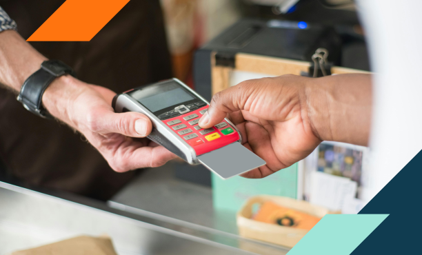 Photo of a person paying with a credit card at a retail store