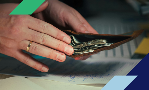 person putting money in wallet while doing paperwork